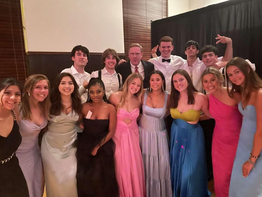 History teacher and chaperone Chris Downing poses with some of his Class of 2022 seniors at the prom.