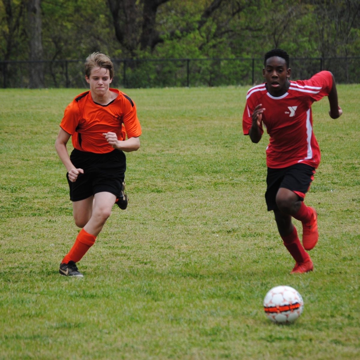 Tommy Beason 24 showing his toughest face as he attempts to beat his opponent to the ball in his rec-league, middle school soccer game (Kent Lineberger).