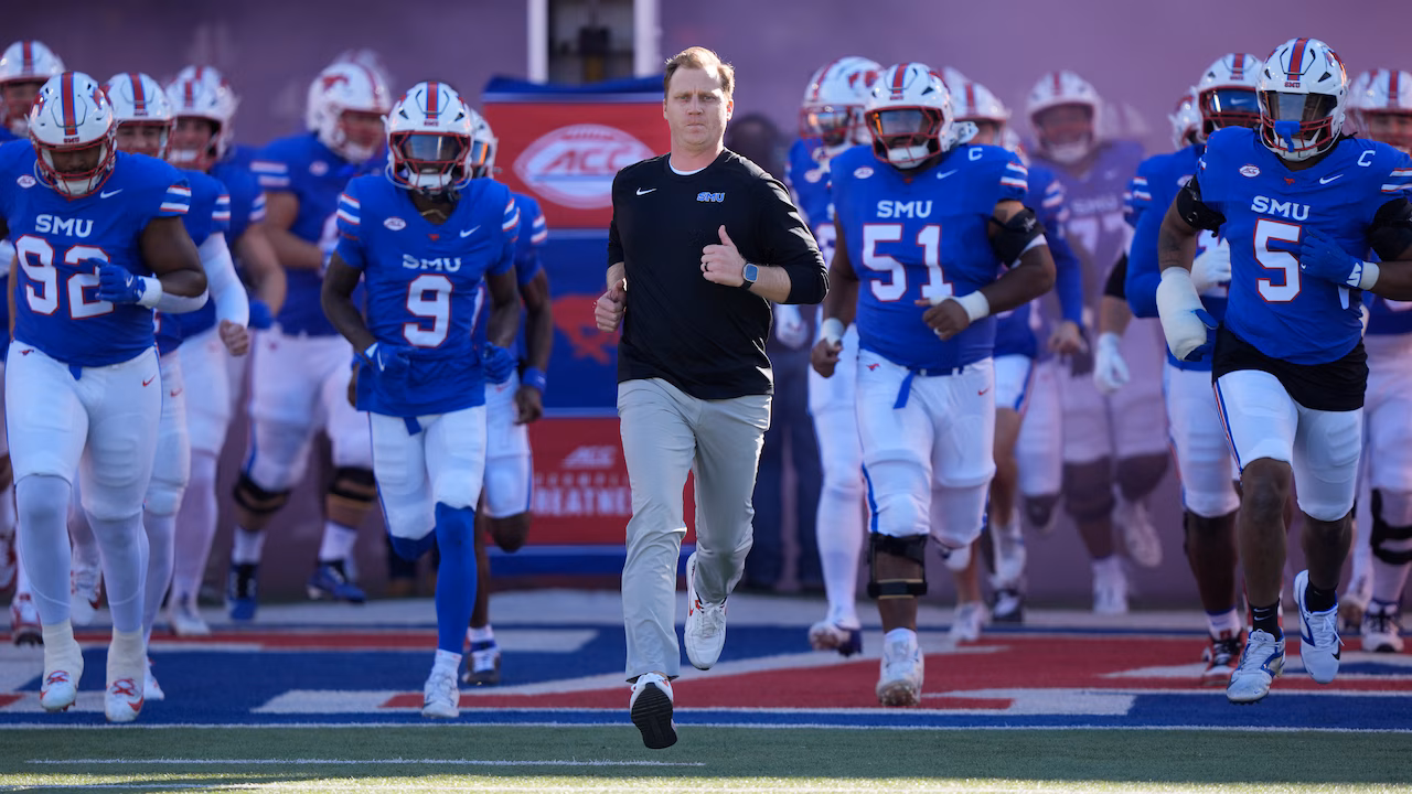 Rhett Lashlee runs out with the SMU football team (photo by LM Otero)
